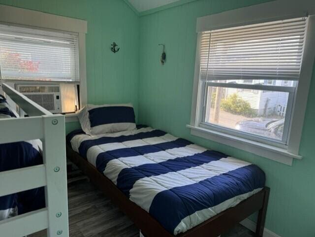 bedroom with lofted ceiling and cooling unit