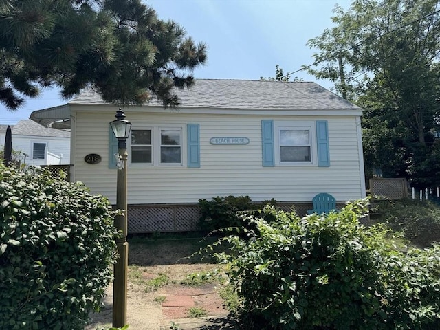 view of front facade with a shingled roof