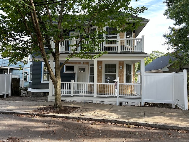 view of front facade featuring a balcony and covered porch