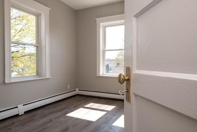 16 Horton St Unit 2, Salem, MA 01970 - spare room with healthy amount of natural light, wood finished floors, and a baseboard heating unit