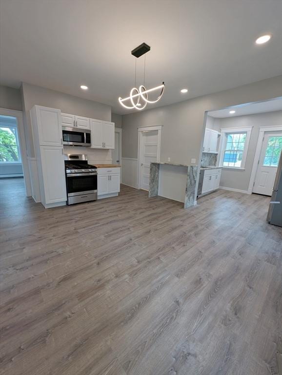 16 Horton St Unit 2, Salem, MA 01970 - kitchen with appliances with stainless steel finishes, white cabinetry, recessed lighting, light wood-style floors, and healthy amount of natural light