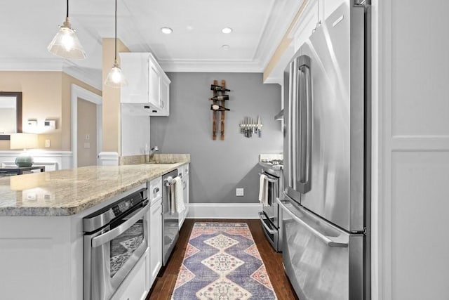 kitchen featuring white cabinets, dark wood-style flooring, crown molding, appliances with stainless steel finishes, and a sink