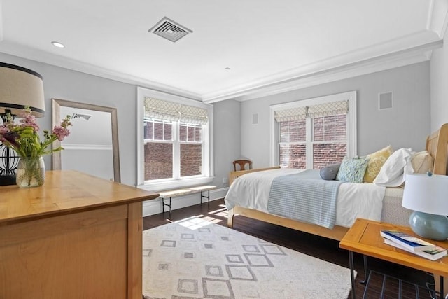 bedroom with visible vents, ornamental molding, dark wood-type flooring, and multiple windows