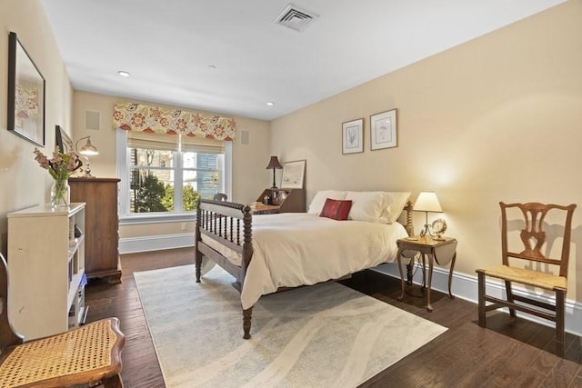 bedroom with baseboards, visible vents, and dark wood-type flooring