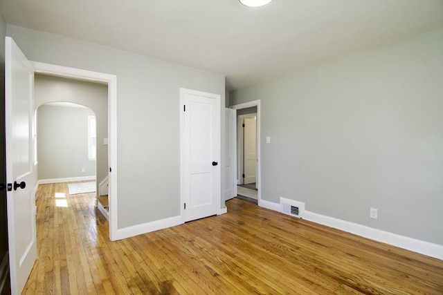 100 Haskin St, Springfield, MA 01109 - unfurnished bedroom featuring arched walkways and light wood-style floors