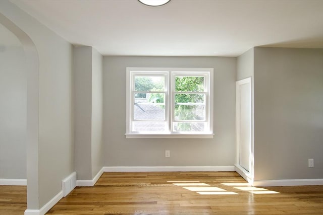 100 Haskin St, Springfield, MA 01109 - empty room featuring arched walkways and light wood finished floors