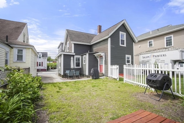 24 Everett St, Woburn, MA 01801 - back of house with a chimney, a patio area, and roof with shingles