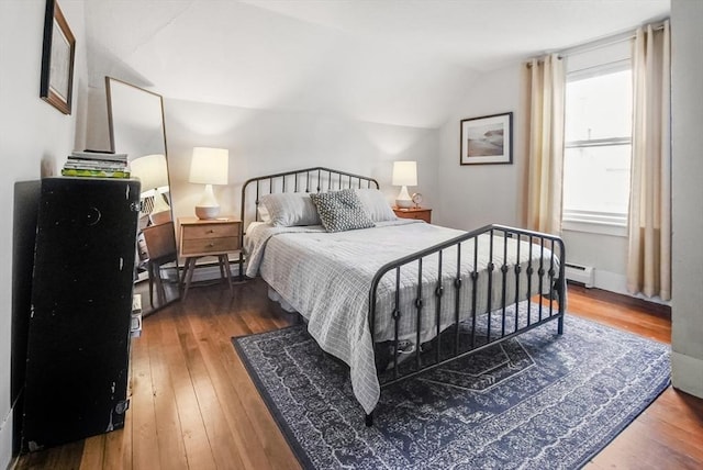 24 Everett St, Woburn, MA 01801 - bedroom with a baseboard heating unit, hardwood / wood-style flooring, and vaulted ceiling