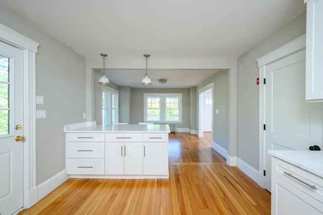 9 School St, Hull, MA 02045 - kitchen with light countertops, radiator, white cabinetry, and light wood finished floors