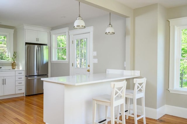 9 School St, Hull, MA 02045 - kitchen with freestanding refrigerator, a healthy amount of sunlight, and light wood-style floors