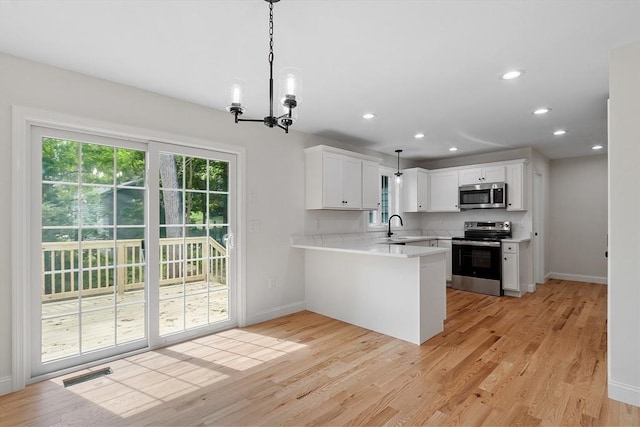 7 S Porter St Unit 7, Haverhill, MA 01835 - kitchen featuring stainless steel appliances, light countertops, recessed lighting, white cabinetry, and light wood finished floors