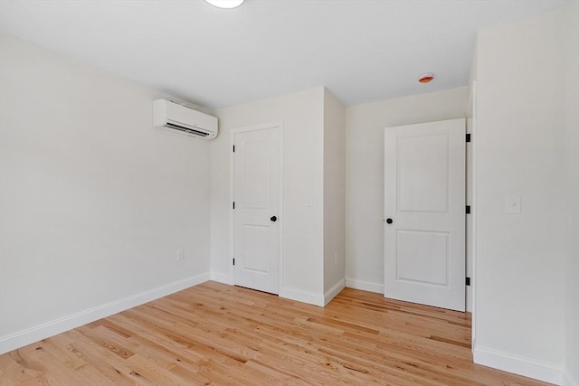 7 S Porter St Unit 7, Haverhill, MA 01835 - unfurnished bedroom featuring a wall mounted AC and light wood finished floors