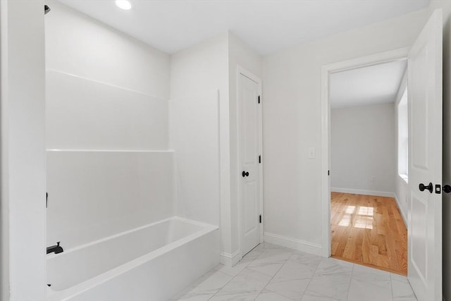 7 S Porter St Unit 7, Haverhill, MA 01835 - bathroom with a tub to relax in, marble look tile flooring, and recessed lighting