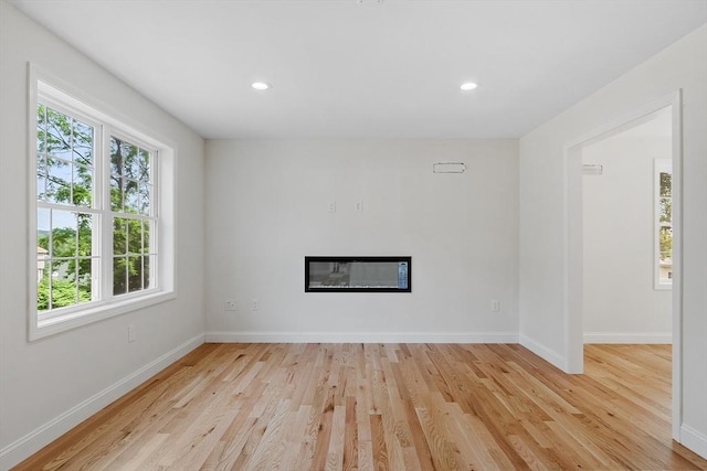 7 S Porter St Unit 7, Haverhill, MA 01835 - unfurnished room with wood finished floors, a glass covered fireplace, and recessed lighting