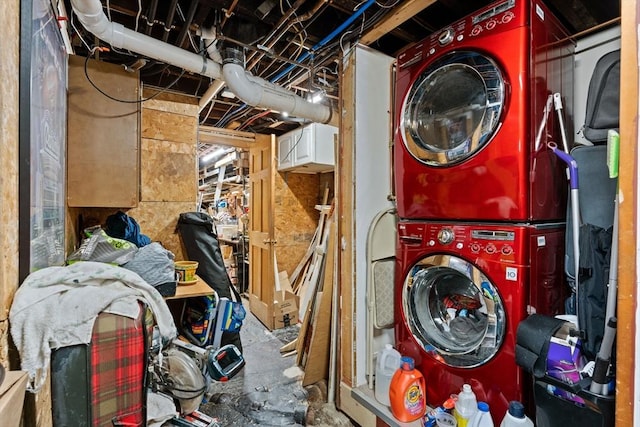 clothes washing area with laundry area and stacked washer and dryer