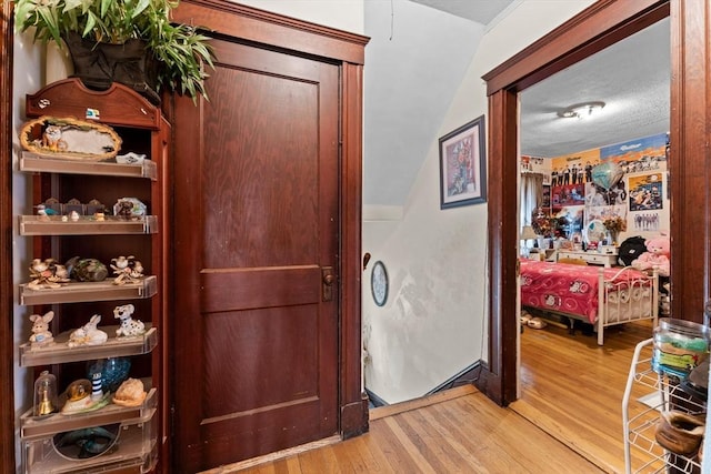 hall featuring wood finished floors and a textured ceiling