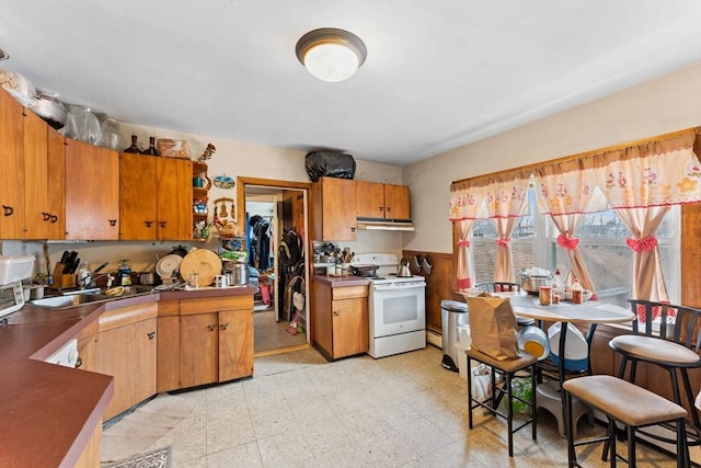 kitchen featuring light floors, open shelves, electric range, a sink, and under cabinet range hood