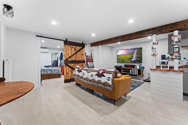 interior space with light wood finished floors, a wall mounted AC, recessed lighting, a barn door, and beamed ceiling