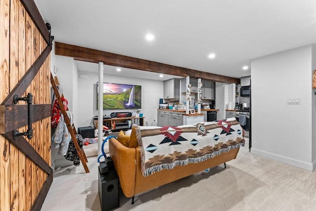 living room with recessed lighting, a barn door, baseboards, and beam ceiling