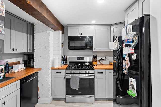 kitchen with beam ceiling, wooden counters, and black appliances