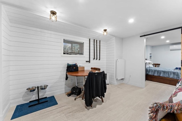 office with an AC wall unit, light wood-style flooring, recessed lighting, a barn door, and baseboards