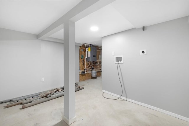 finished below grade area featuring water heater, baseboards, and recessed lighting