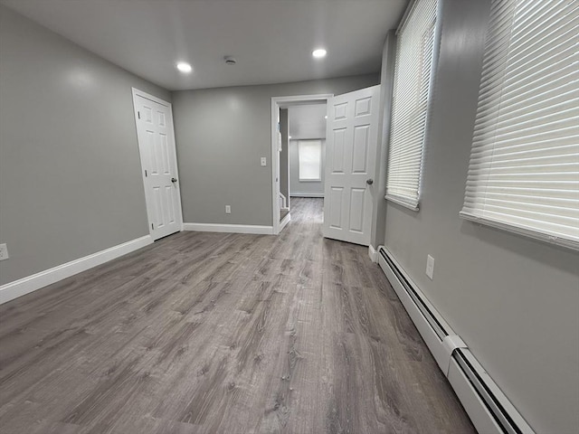 103 Pleasent, Woonsocket, RI 02895 - spare room featuring a baseboard heating unit, wood finished floors, baseboards, recessed lighting, and a smoke detector