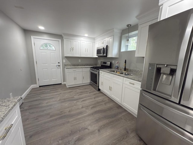 103 Pleasent, Woonsocket, RI 02895 - kitchen with stainless steel appliances, a sink, white cabinetry, light stone countertops, and wood finished floors