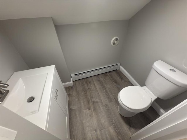 103 Pleasent, Woonsocket, RI 02895 - bathroom featuring a baseboard heating unit, toilet, wood finished floors, baseboards, and vanity