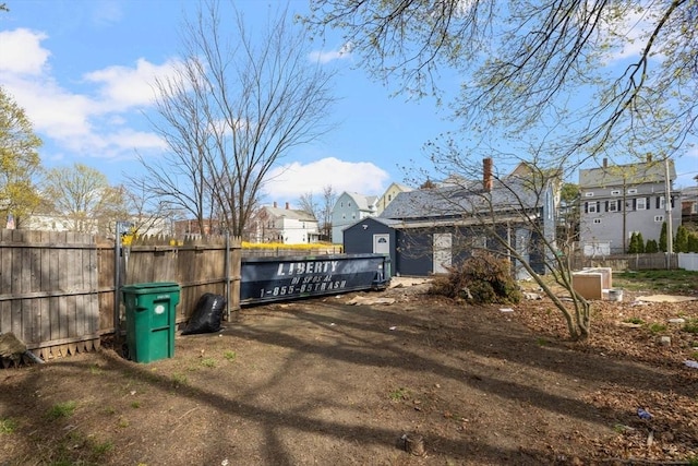 view of side of property with fence, a residential view, and a gate