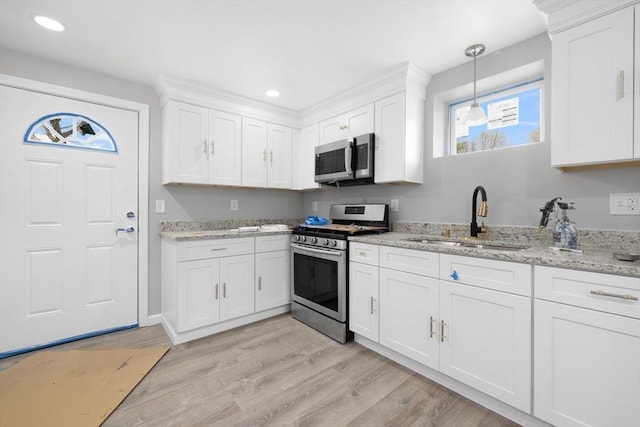 kitchen with stainless steel appliances, a sink, white cabinetry, and recessed lighting