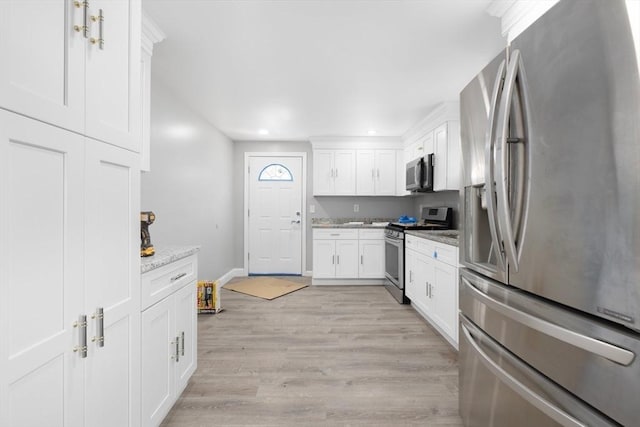 kitchen with stainless steel appliances, white cabinetry, light wood finished floors, baseboards, and recessed lighting