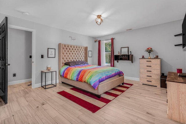 bedroom with wood finished floors and baseboards