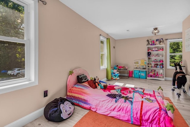 bedroom with baseboards and wood finished floors