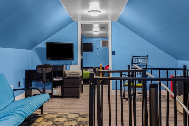 interior space with vaulted ceiling and wood finished floors