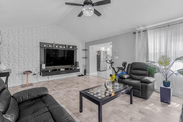 living room featuring lofted ceiling, baseboards, wood finished floors, and ceiling fan