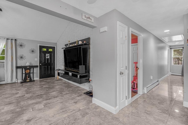 interior space with attic access, baseboard heating, baseboards, and vaulted ceiling
