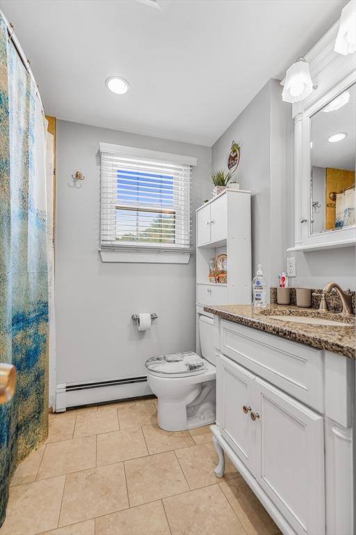 bathroom with toilet, recessed lighting, tile patterned flooring, vanity, and a baseboard radiator