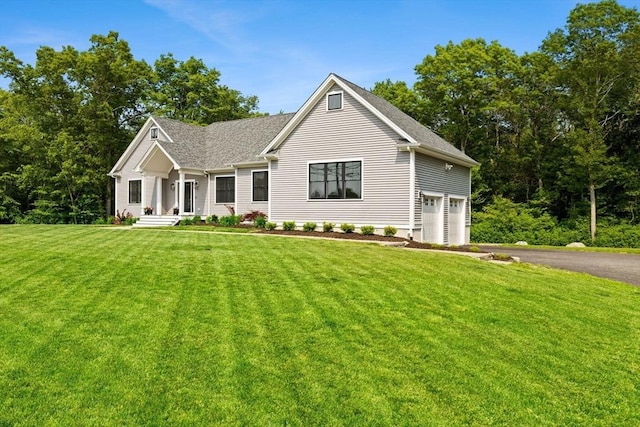 751 Sharps Lot Rd, Swansea, MA 02777 - view of front of home featuring asphalt driveway, a front lawn, a garage, and roof with shingles