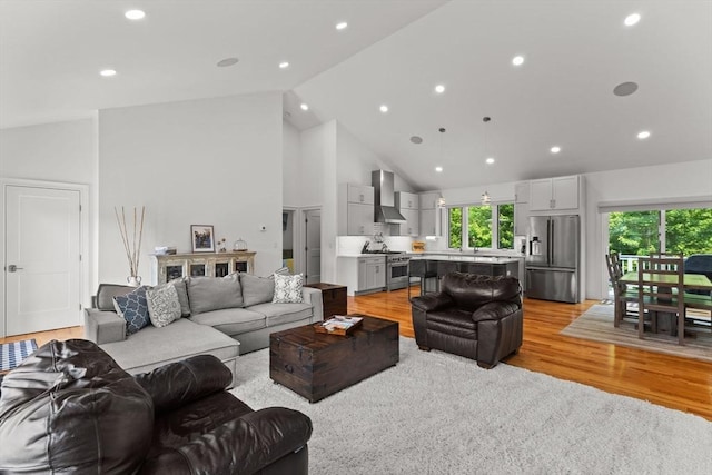 751 Sharps Lot Rd, Swansea, MA 02777 - living area featuring light wood finished floors, high vaulted ceiling, and recessed lighting