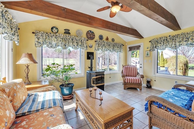 tiled living area with baseboards, vaulted ceiling with beams, and a ceiling fan