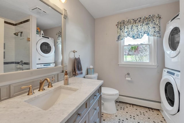 bathroom featuring stacked washer and dryer, toilet, a baseboard radiator, visible vents, and a stall shower