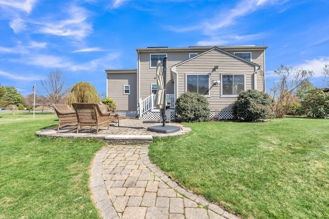 rear view of house featuring a yard and a patio area
