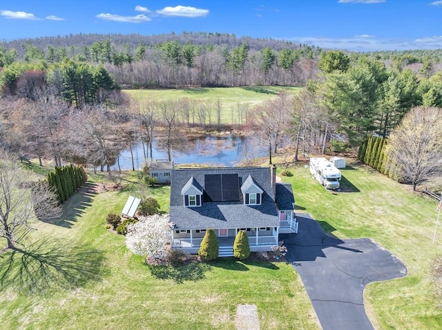 aerial view featuring a water view and a wooded view