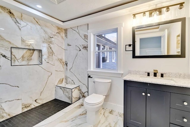 bathroom featuring a shower, vanity, and toilet