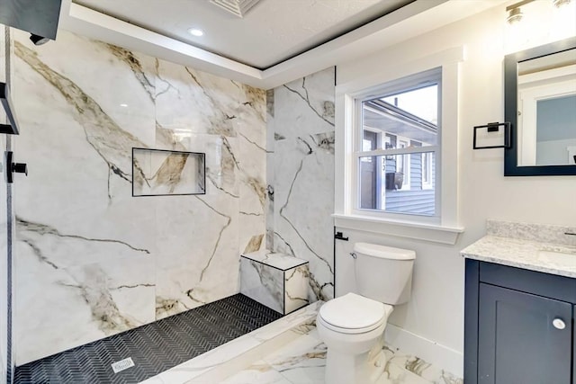 bathroom with vanity, toilet, walk in shower, and a tray ceiling