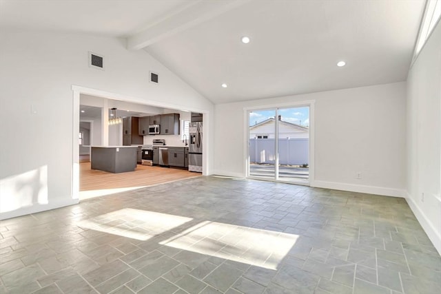 unfurnished living room featuring beamed ceiling and high vaulted ceiling