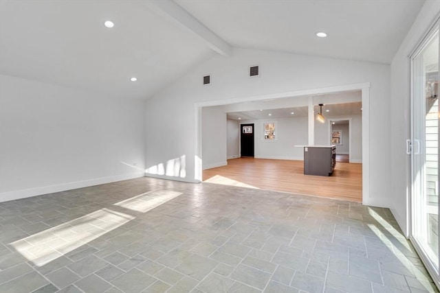 unfurnished living room with beamed ceiling and high vaulted ceiling