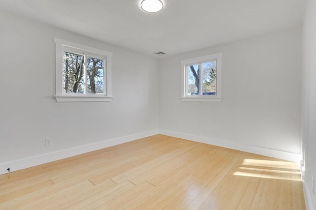 spare room with hardwood / wood-style floors