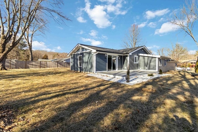 back of property featuring a patio area and a yard